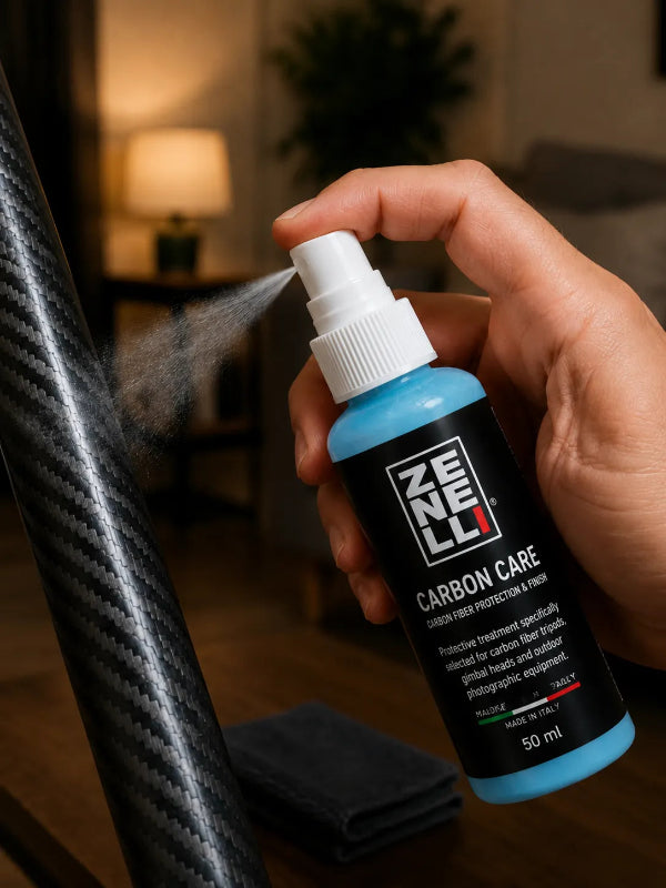 Hand applying Zenelli Carbon Care protective spray on carbon fiber photography equipment