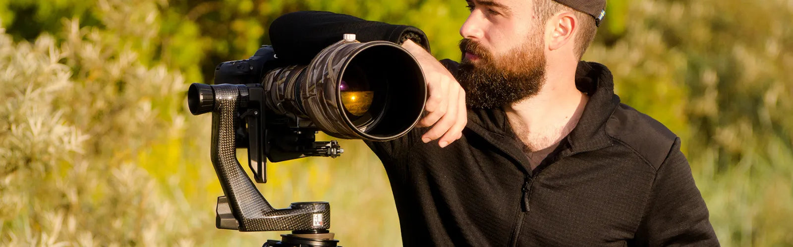 professional camera setup with tripod and telephoto lens for wildlife photography